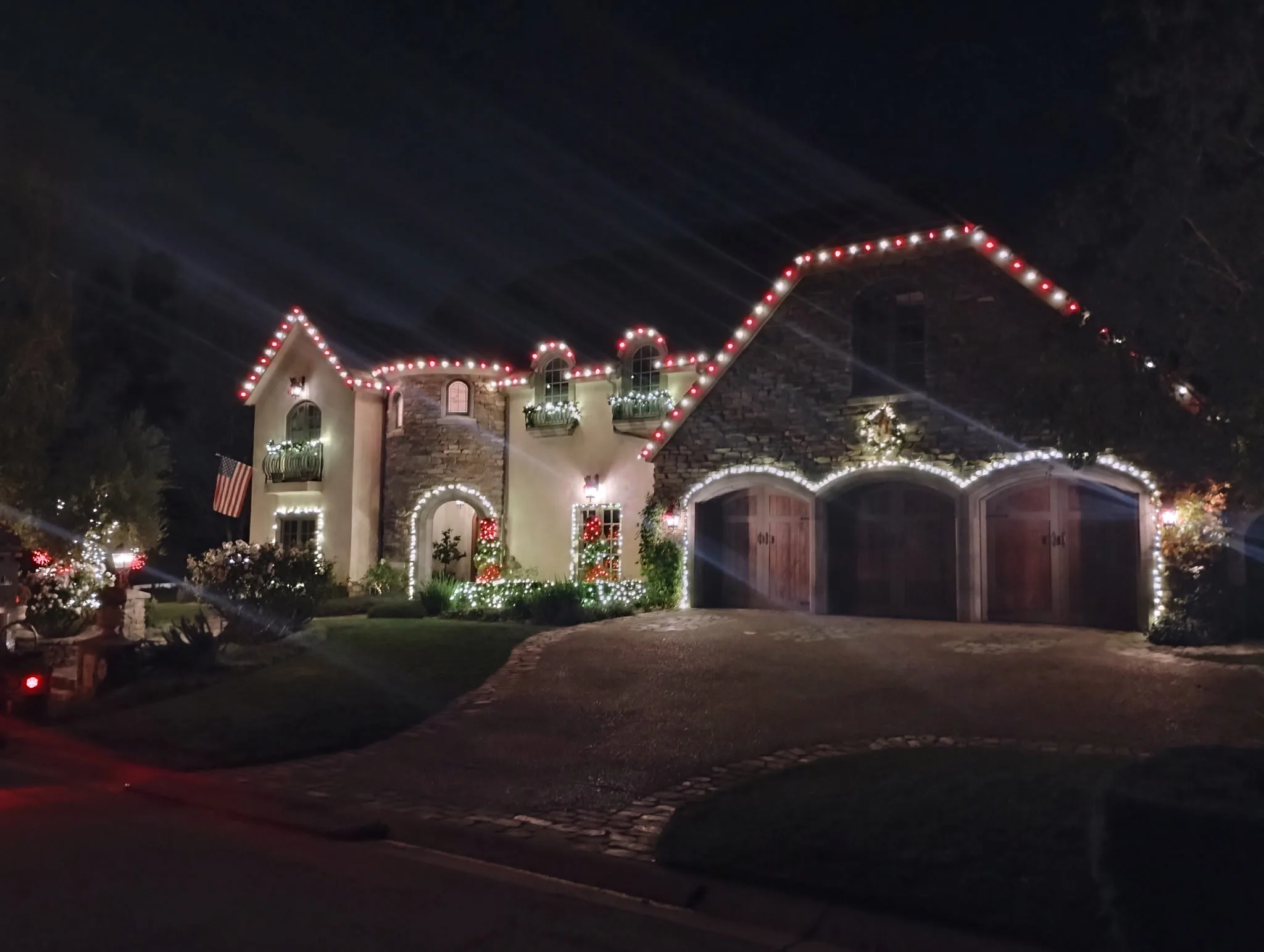 Estate glowing with warm-white and accent lighting for a celebration by Bee Merry